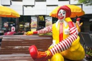 Statue of Ronald McDonald sits on a bench outside of a McDonald's in Bangkok, Thailand.