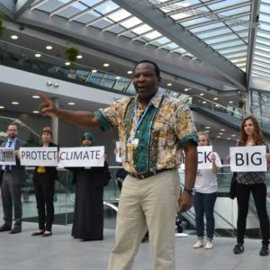Godwin Ojo of Environmental Rights Action/Friends of the Earth Nigeria delivering a call to the U.N. in front of an action at this week’s U.N. climate treaty meetings. Photo credit: Corporate Accountability International