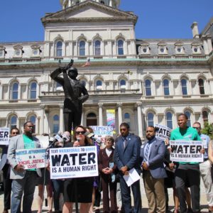 A crowd of activists and councilmembers gathers in Baltimore to call for the passage of the Water Accountability and Equity Act.